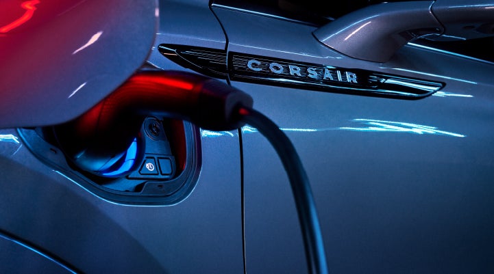 A charger plugged into the charging port of a 2024 Lincoln Corsair® Plug-in Hybrid model. | Beach Lincoln in Myrtle Beach SC